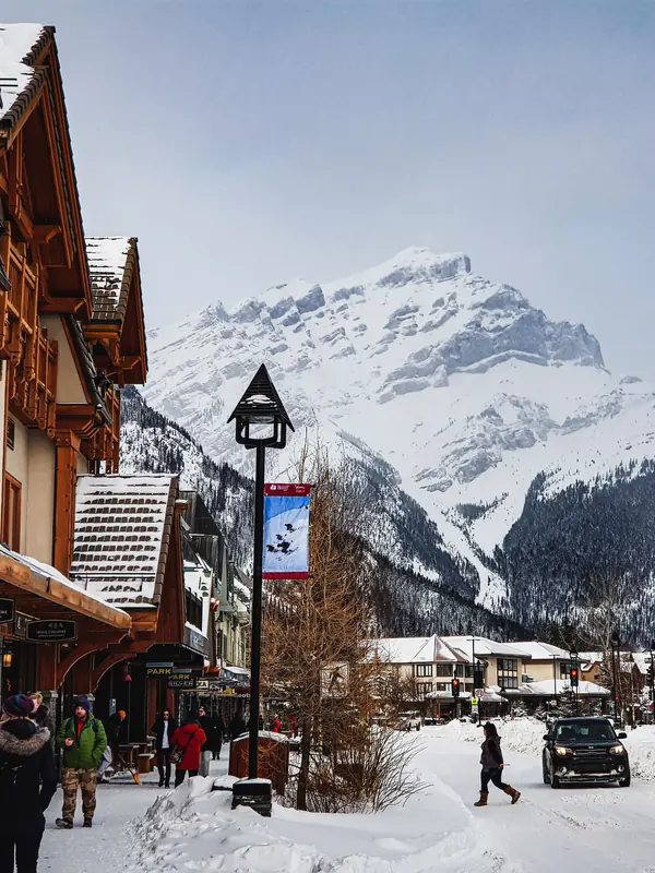 Banff Avenue in snow with Cascade Mountain behind