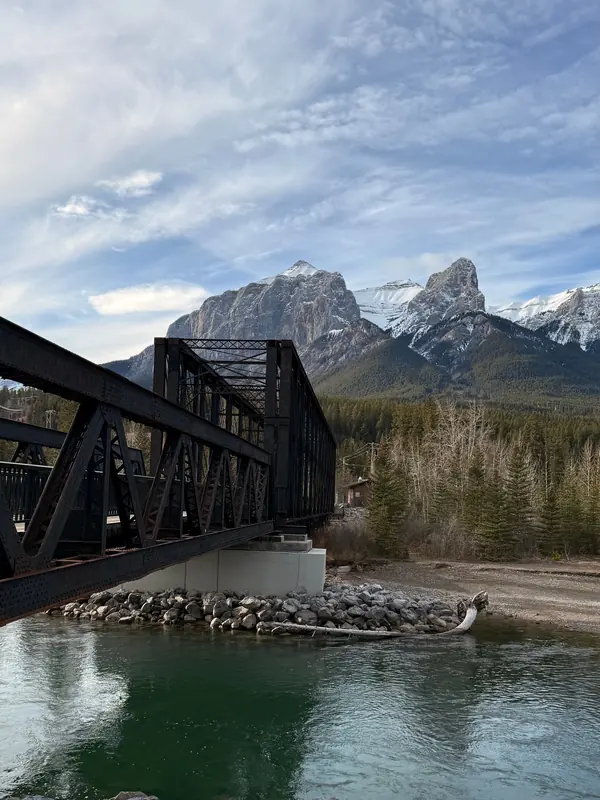 The Three Sisters peaks above the Bow River at Canmore